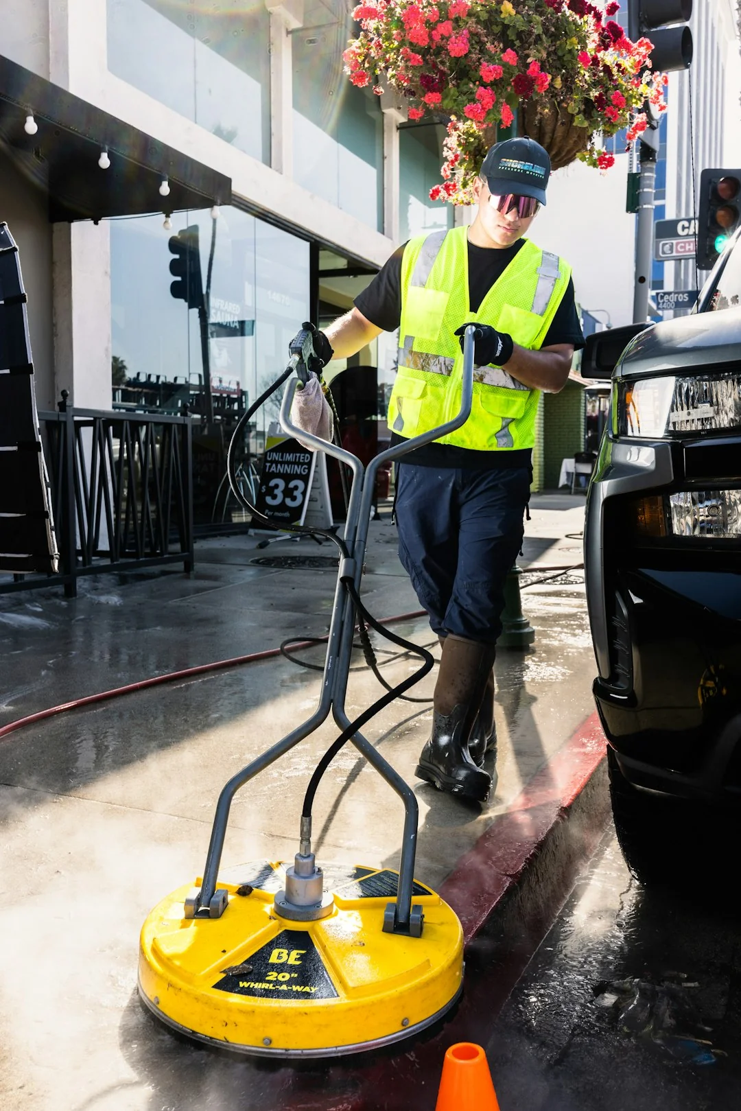A skilled cleaner wearing protective gear is vacuuming the floor in a contemporary living room.